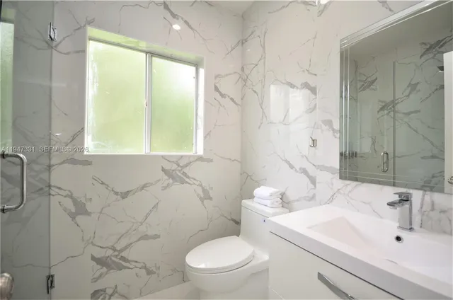 a bathroom with a sink a toilet and shower curtain