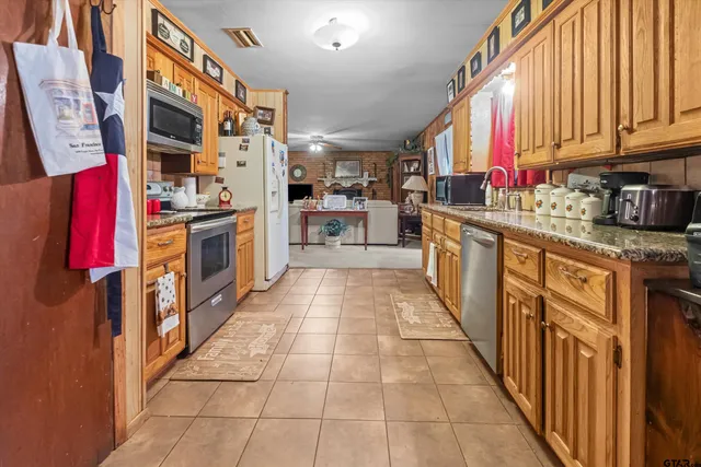 a kitchen with stainless steel appliances granite countertop a stove and cabinets