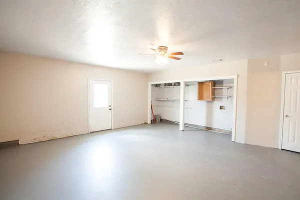 an empty room with a empty space and windows