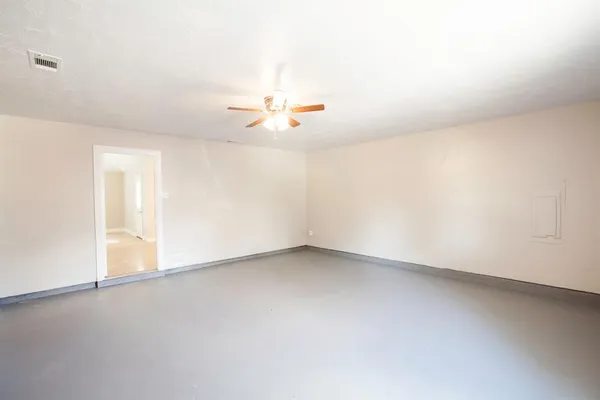 an empty room with a empty space and a ceiling fan