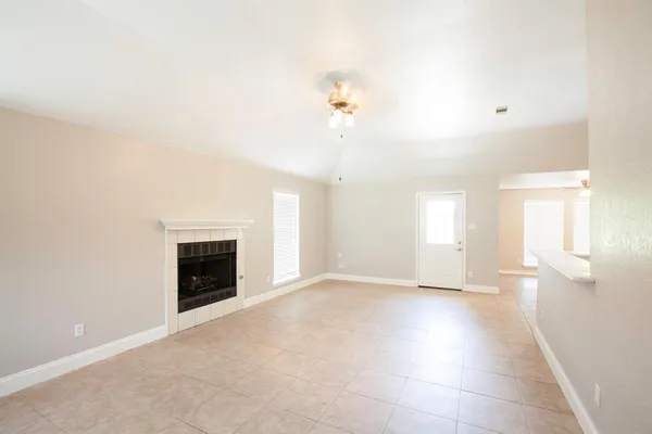 a view of empty room with a fireplace