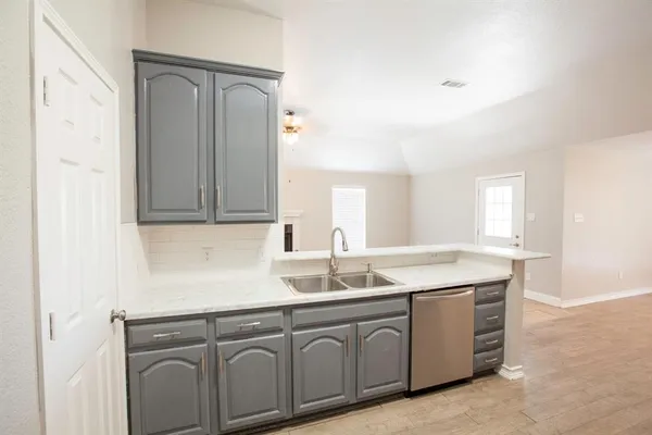 a sink with white cabinets