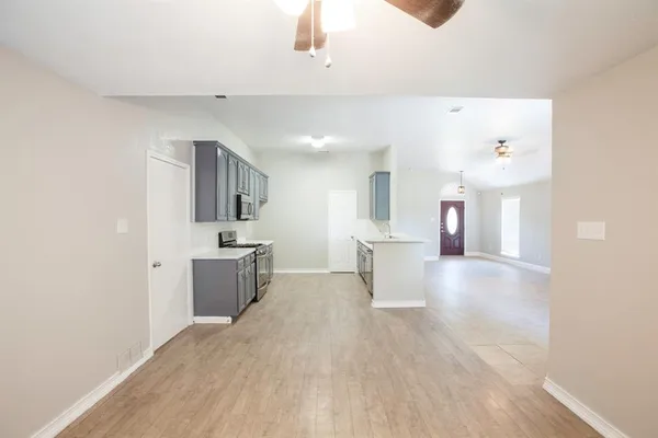 a view of a kitchen with a sink and a refrigerator