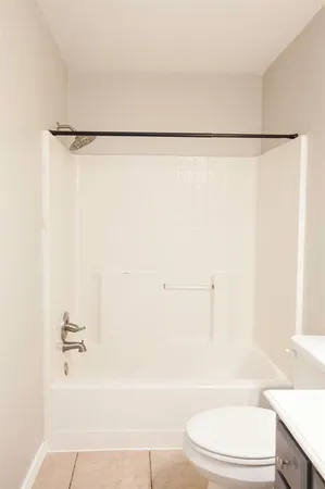 a bathroom with a bathtub and a toilet