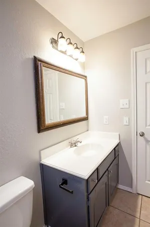 a bathroom with a sink vanity and a mirror