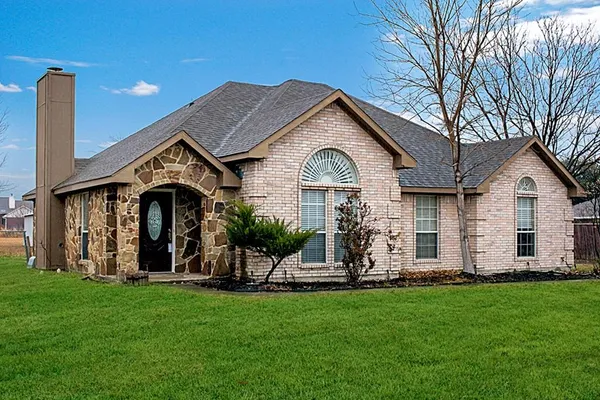 a front view of house with yard and outdoor seating
