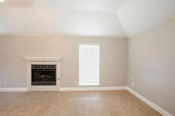 a living room with a fireplace and a window