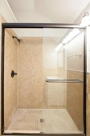 a bathroom with a glass shower door