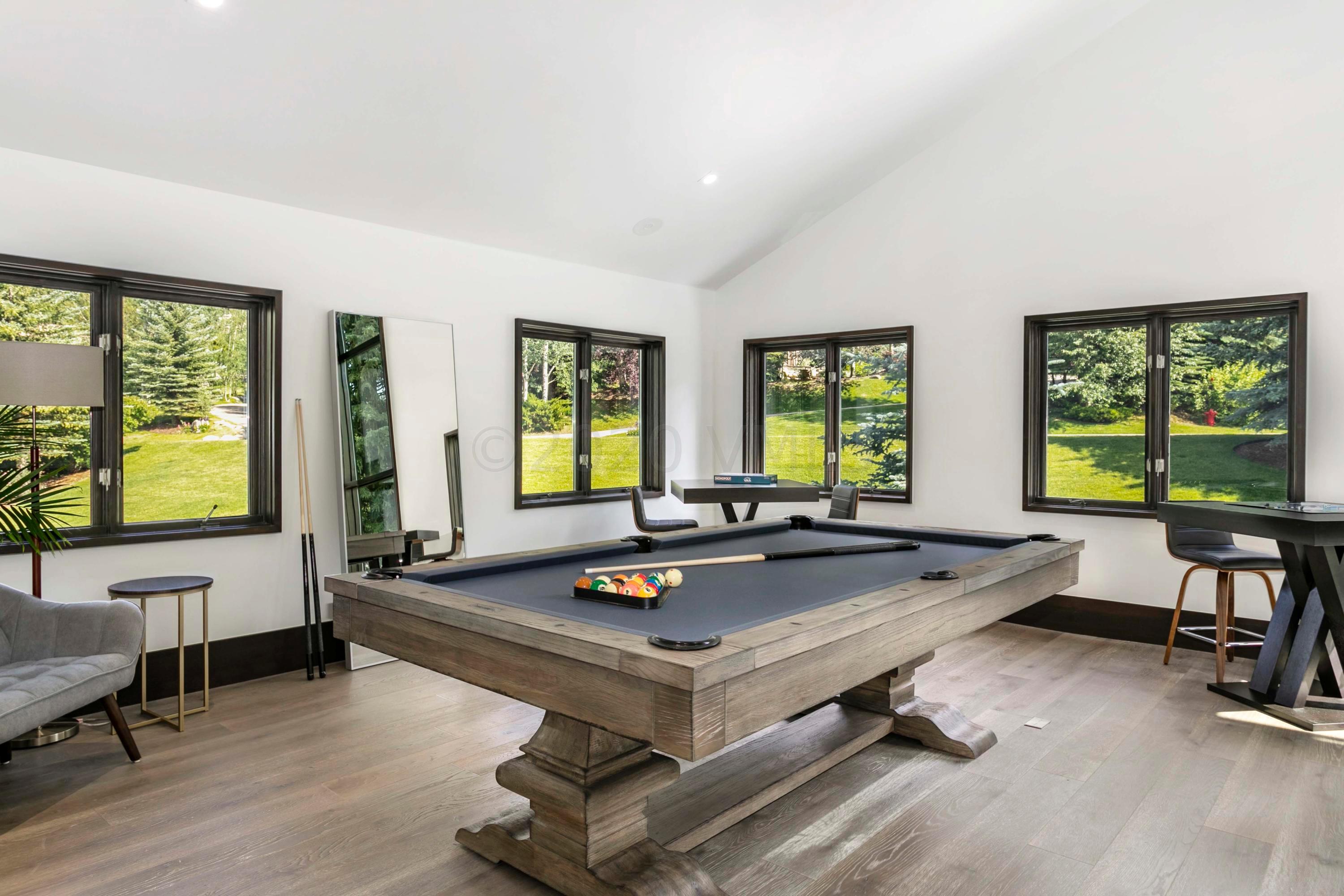 144 Castle Peak Gate Edwards, CO 81632 - Photo 30 of 46 a living room with furniture pool table and windows