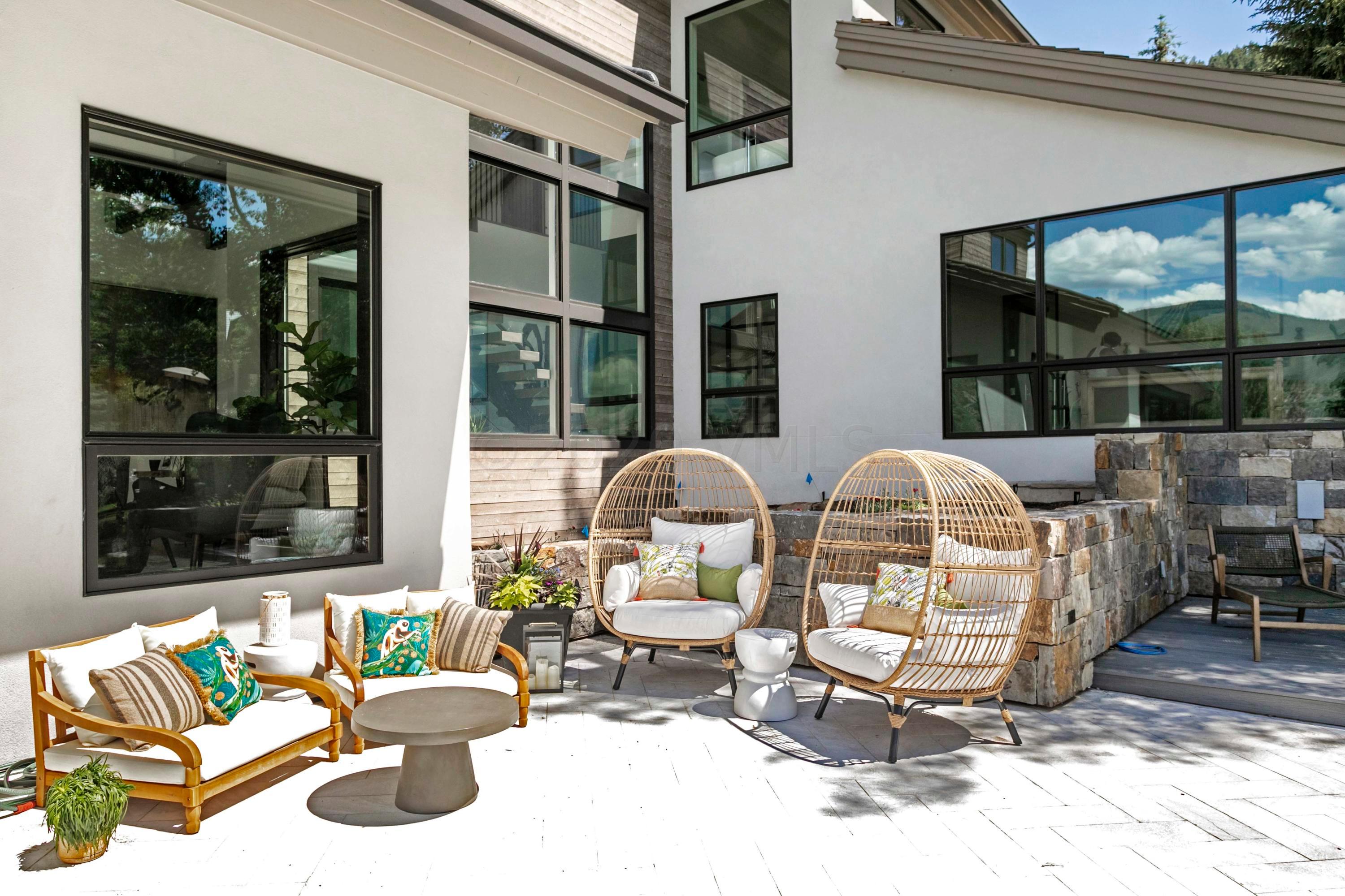 144 Castle Peak Gate Edwards, CO 81632 - Photo 36 of 46 a view of a patio with table and chairs potted plants and a large window