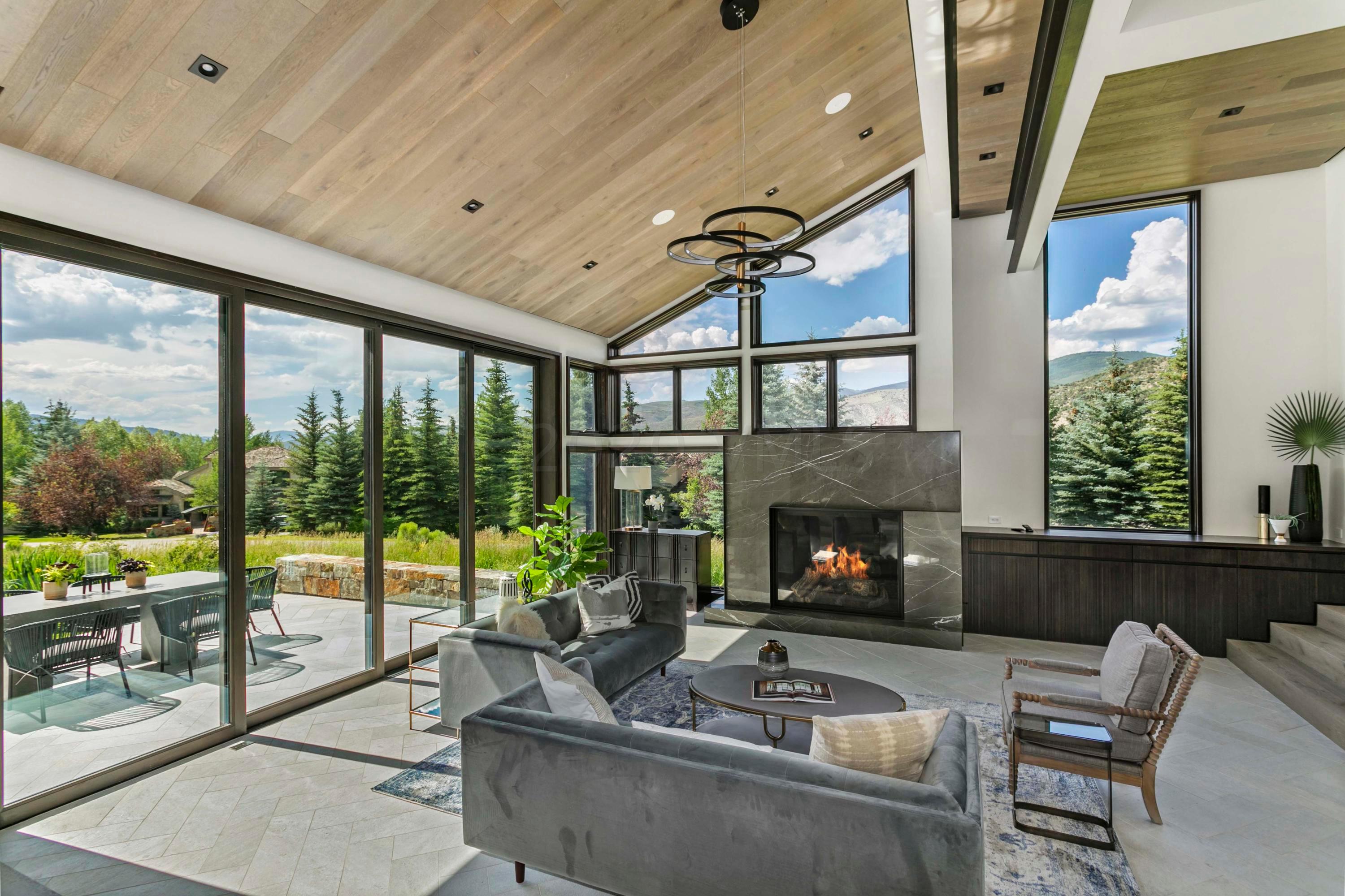 144 Castle Peak Gate Edwards, CO 81632 - Photo 4 of 46 a living room with furniture fireplace and a floor to ceiling window