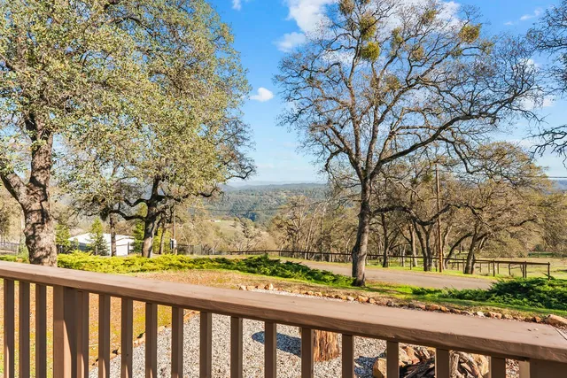 a view of a yard with wooden fence