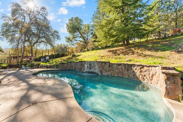 a view of swimming pool with a yard