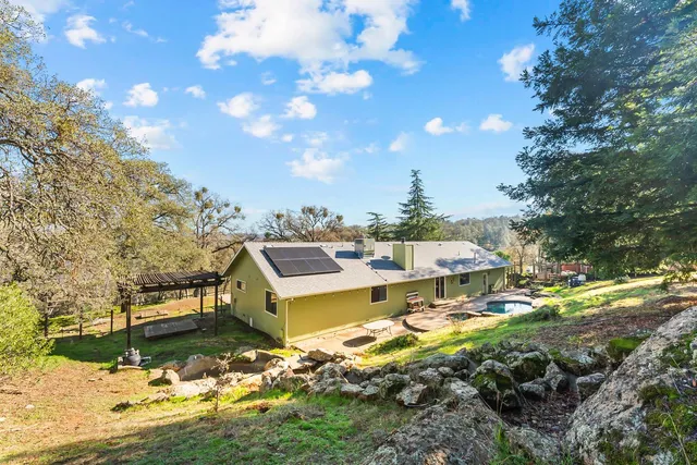 a view of a swimming pool with a patio and a yard