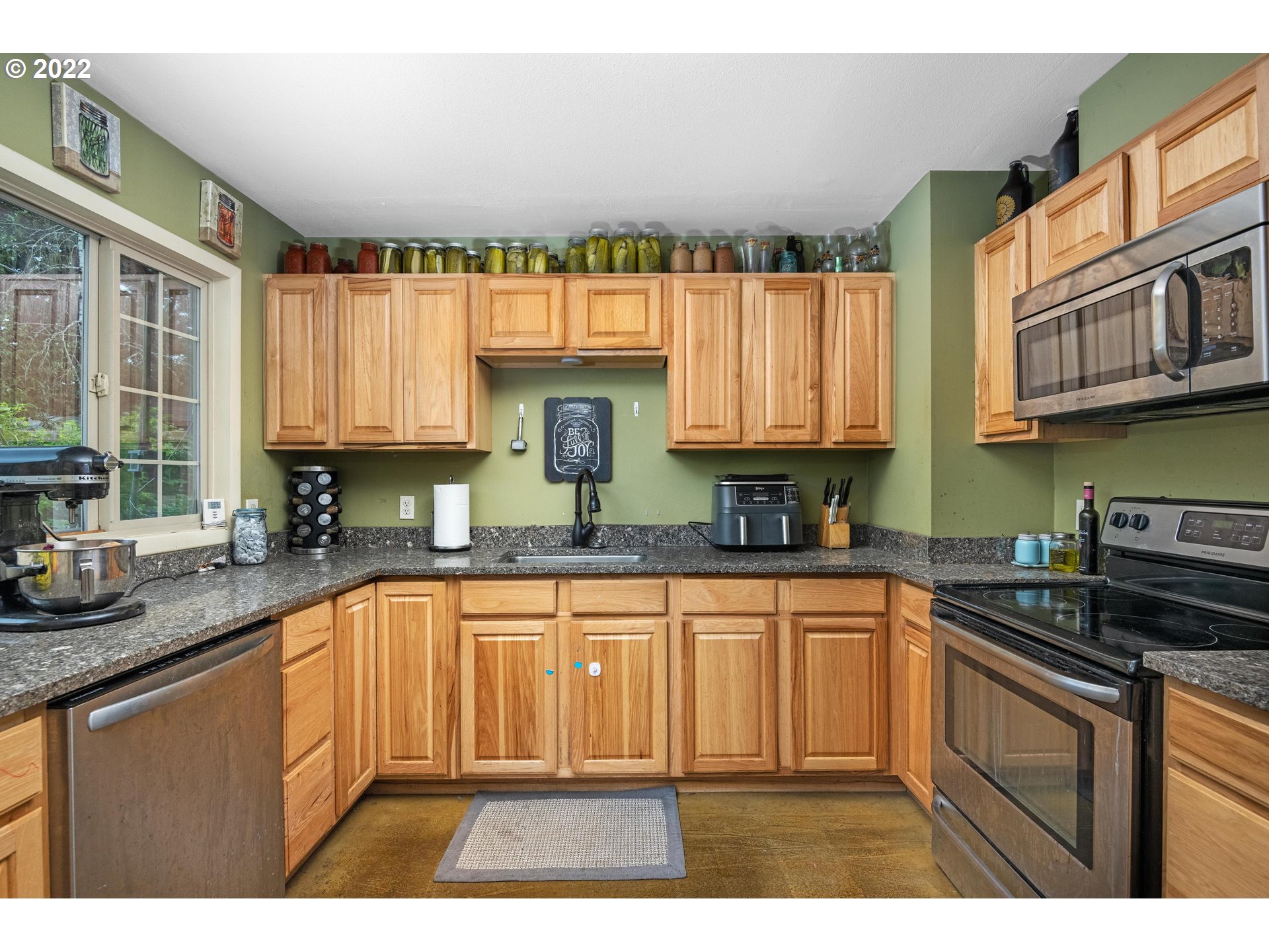 12855 Southwest Douglas Street Portland, OR 97225 - Photo 11 of 32 a kitchen with stainless steel appliances granite countertop a sink a stove and cabinets