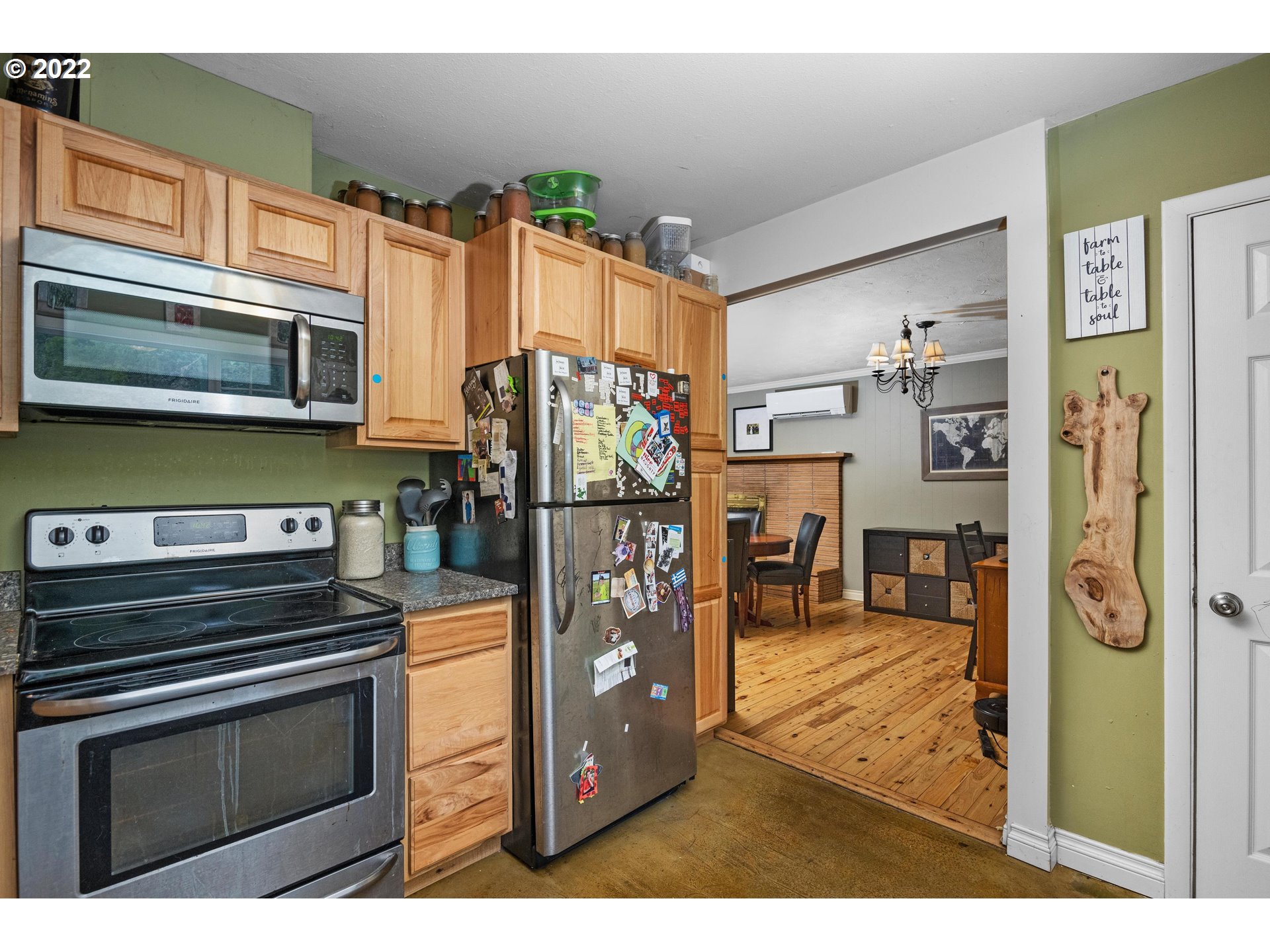 12855 Southwest Douglas Street Portland, OR 97225 - Photo 12 of 32 a kitchen with stainless steel appliances kitchen island a stove refrigerator and microwave
