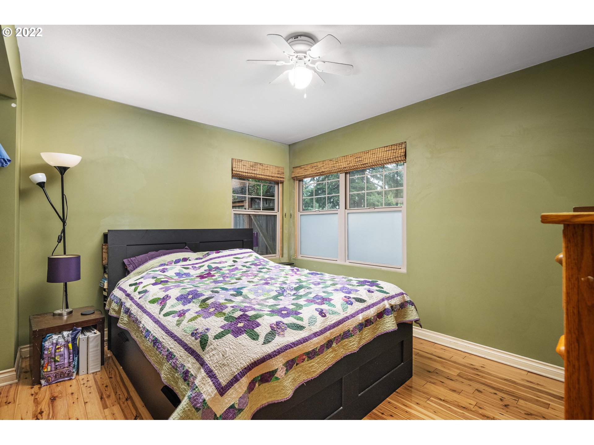 12855 Southwest Douglas Street Portland, OR 97225 - Photo 14 of 32 a bedroom with a bed and a chandelier