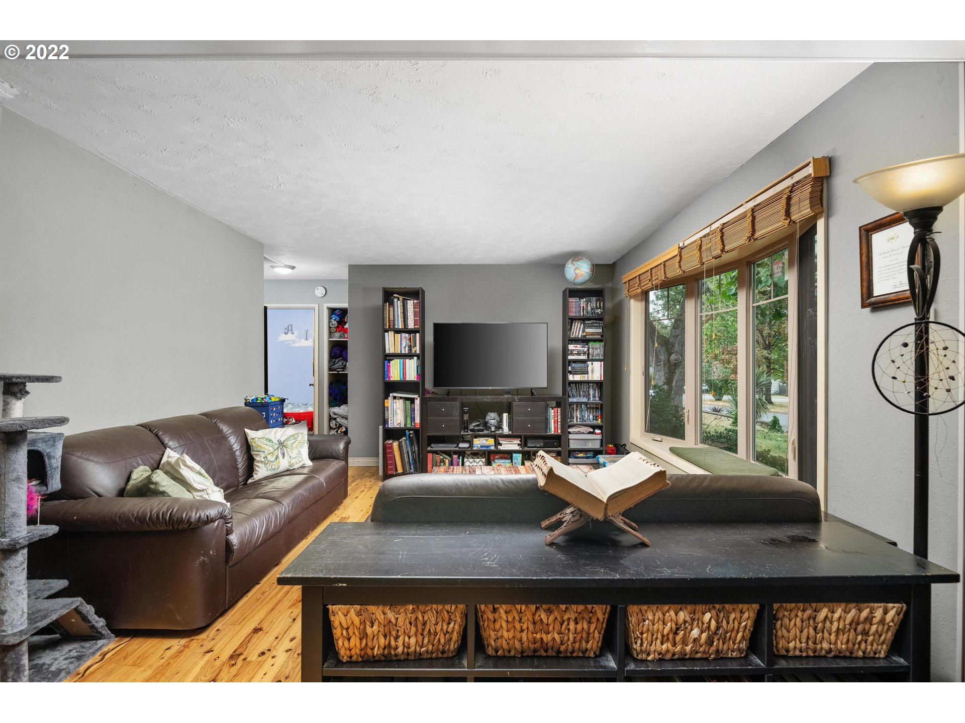 12855 Southwest Douglas Street Portland, OR 97225 - Photo 2 of 32 a living room with furniture a flat screen tv and a large window