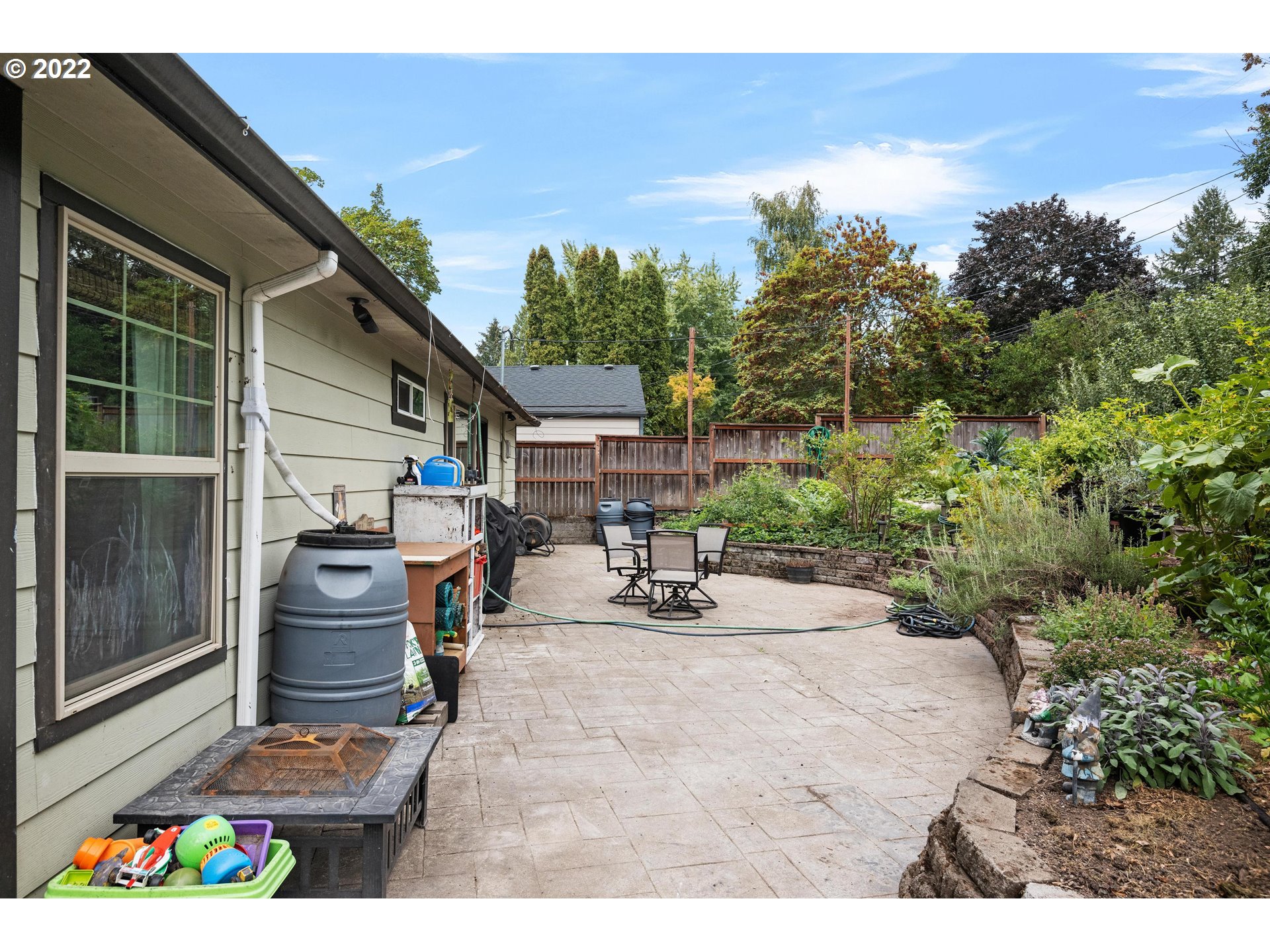 12855 Southwest Douglas Street Portland, OR 97225 - Photo 22 of 32 a view of a patio with table and chairs and potted plants