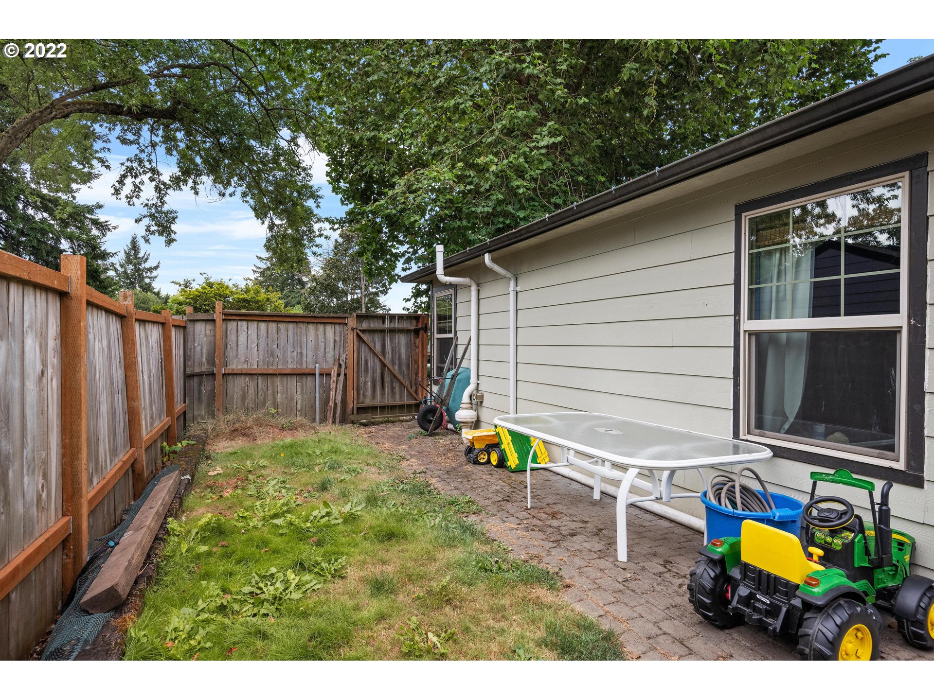 12855 Southwest Douglas Street Portland, OR 97225 - Photo 23 of 32 a view of a backyard with chairs potted plants and wooden fence