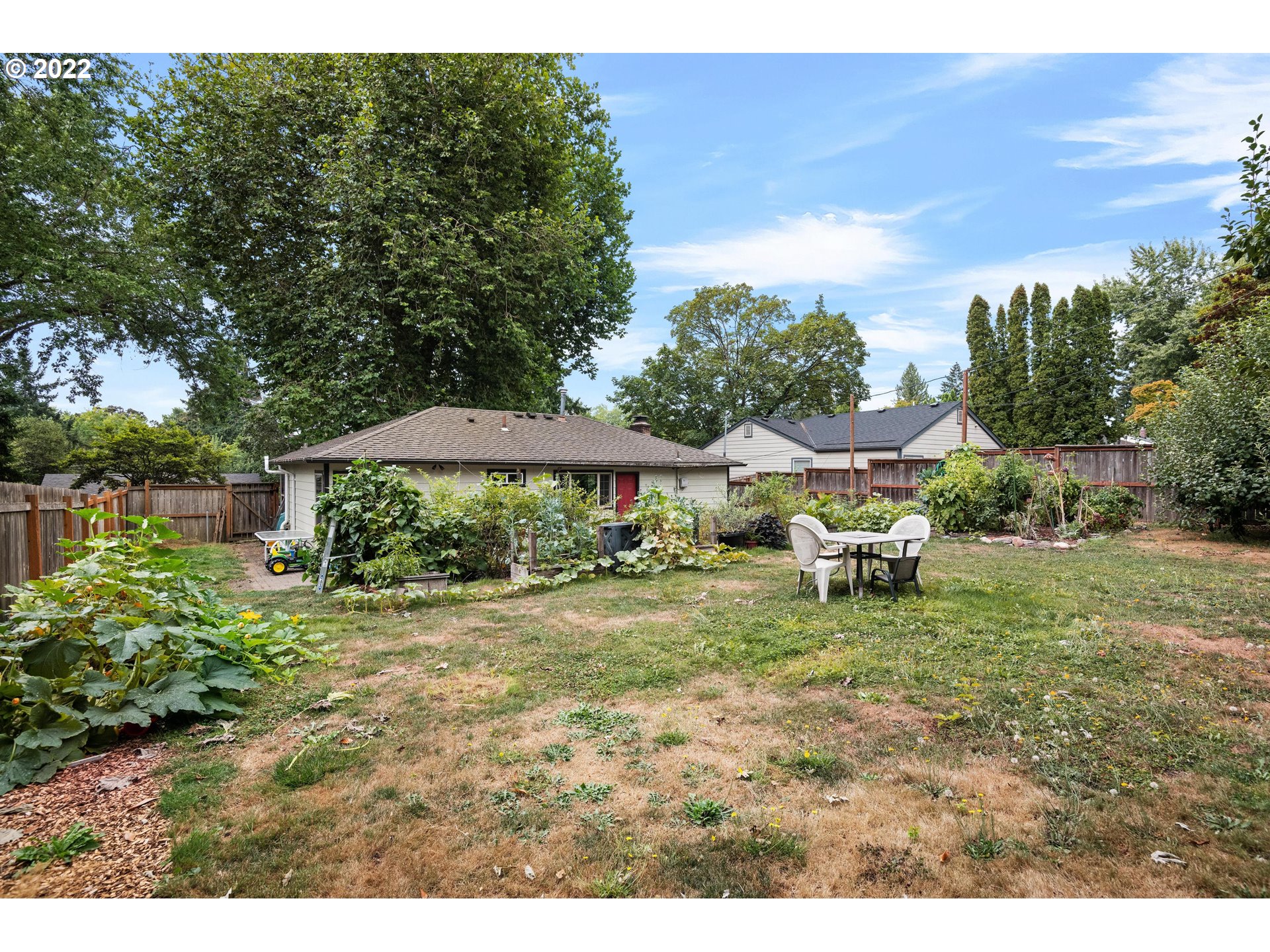 12855 Southwest Douglas Street Portland, OR 97225 - Photo 25 of 32 a backyard of a house with table and chairs