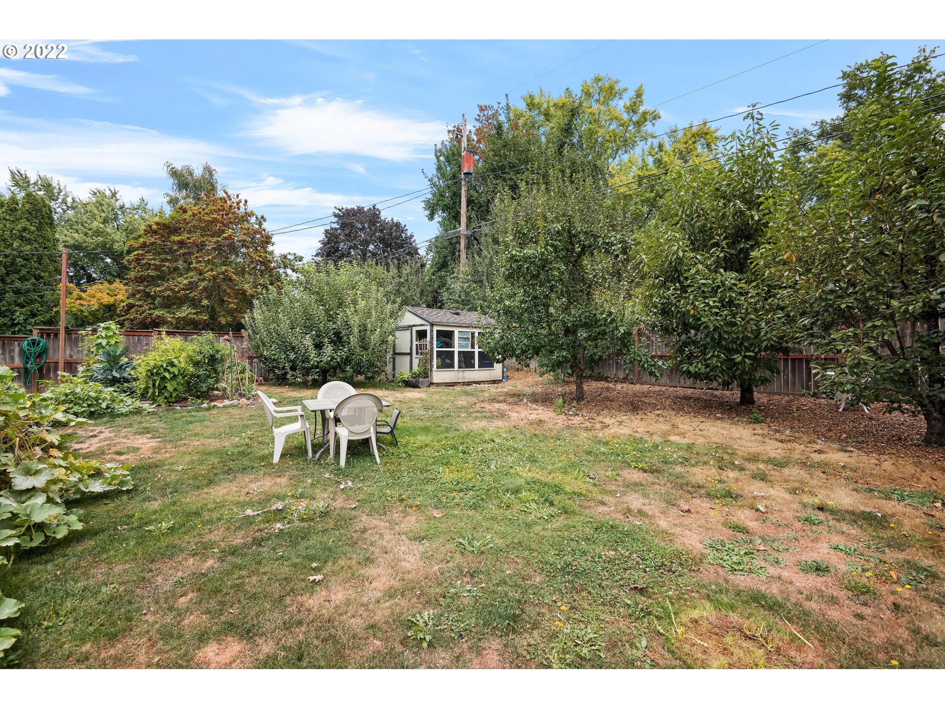 12855 Southwest Douglas Street Portland, OR 97225 - Photo 26 of 32 a backyard of a house with table and chairs