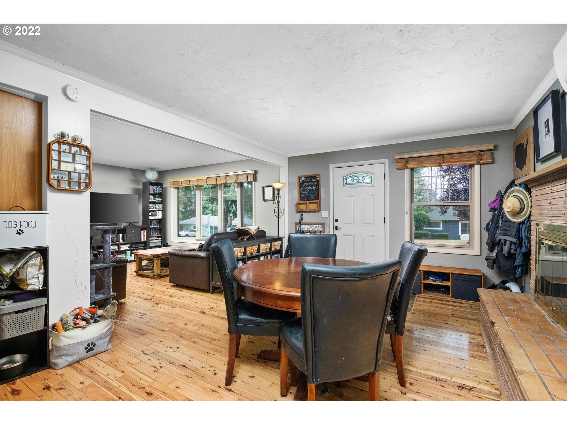 12855 Southwest Douglas Street Portland, OR 97225 - Photo 8 of 32 a dining room with furniture a fireplace and wooden floor