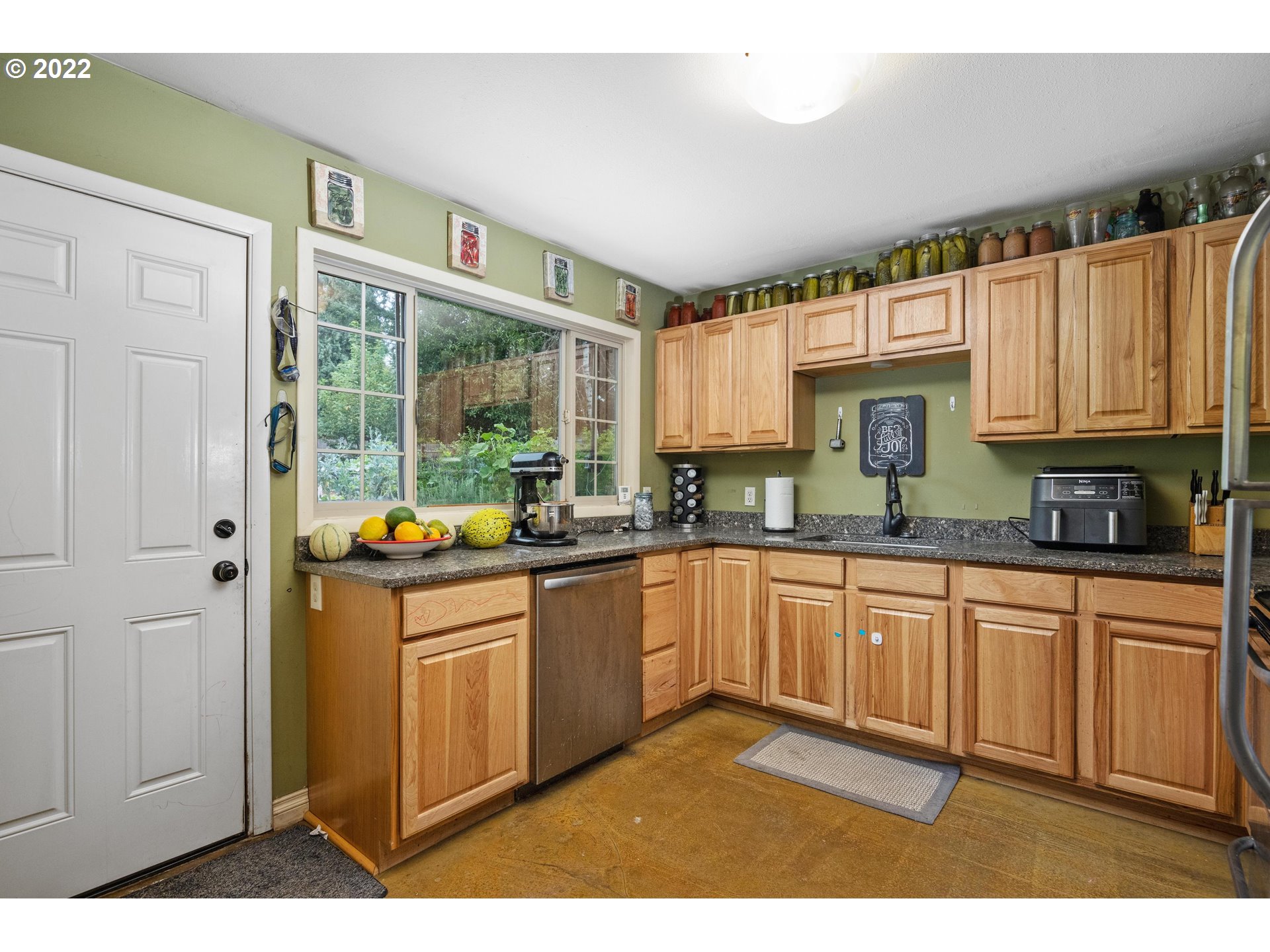 12855 Southwest Douglas Street Portland, OR 97225 - Photo 9 of 32 a kitchen with stainless steel appliances granite countertop a stove a sink and a refrigerator