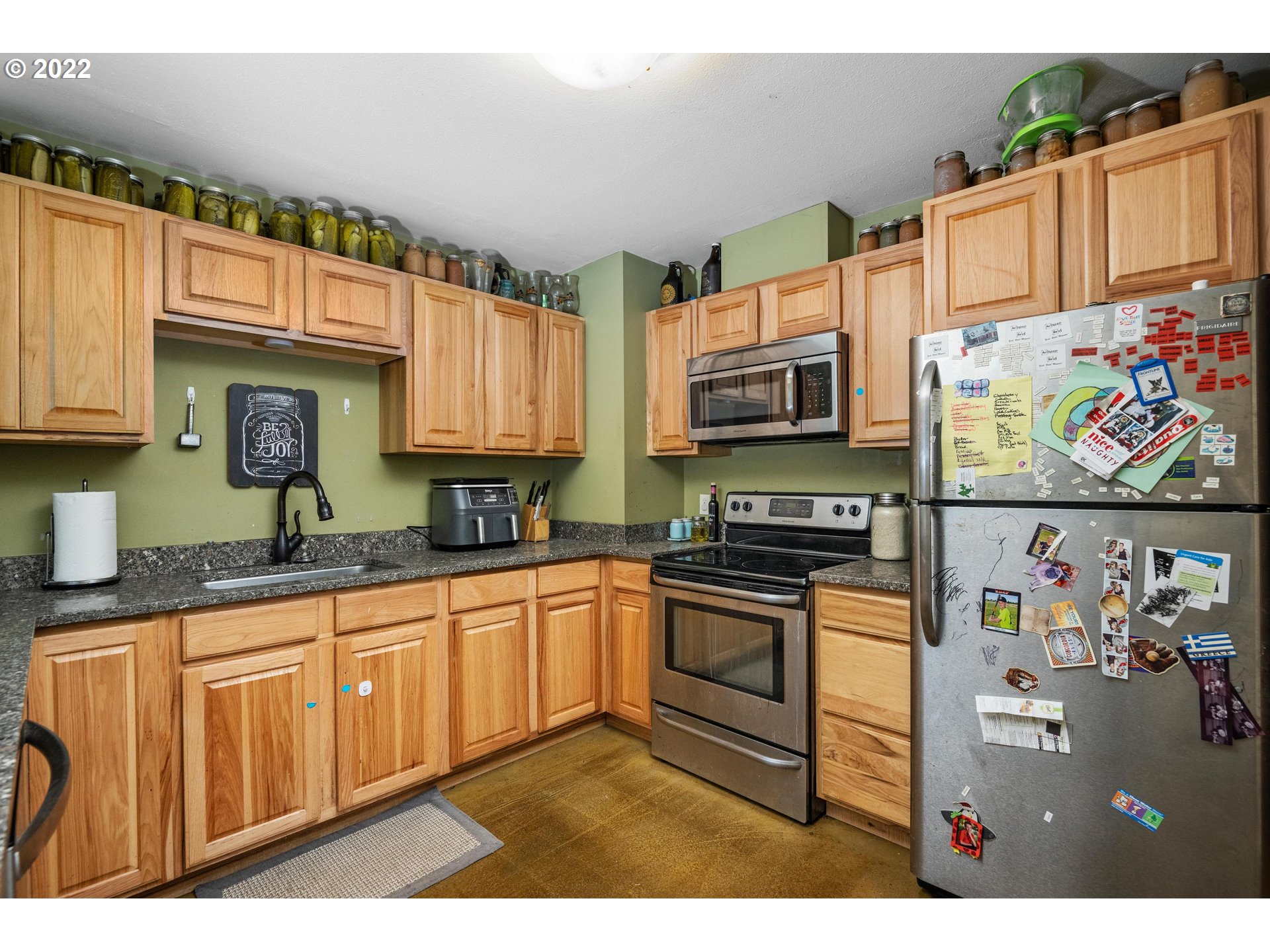 12855 Southwest Douglas Street Portland, OR 97225 - Photo 10 of 32 a kitchen with stainless steel appliances granite countertop a stove top oven a sink dishwasher and cabinets with wooden floor