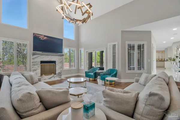a spacious bedroom with a bed a ceiling fan and a couch