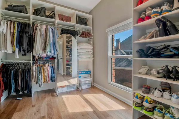 a bedroom with furniture and a wooden floor