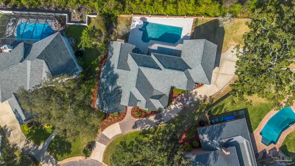 an aerial view of a house with a lake view