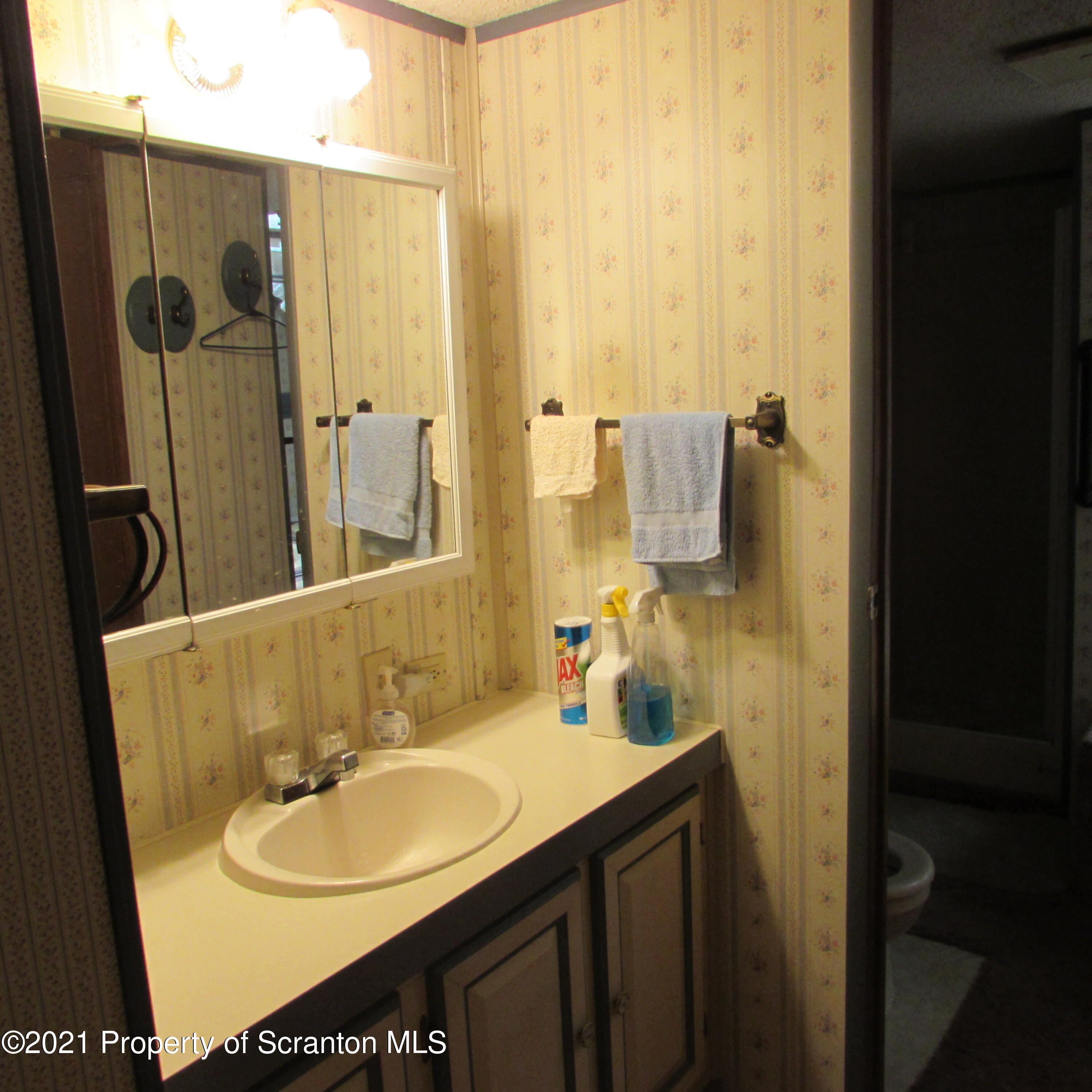 7211 State Rte 3001 Meshoppen, PA 18630 - Photo 15 of 23 a bathroom with a sink and a mirror