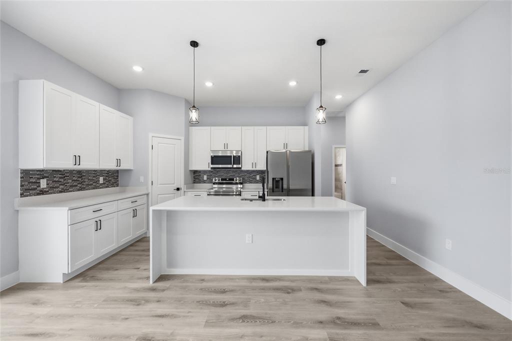 13975 Southwest 27 Ct Road Ocala, FL 34473 - Photo 11 of 35 a view of kitchen with stainless steel appliances granite countertop cabinets and wooden floor