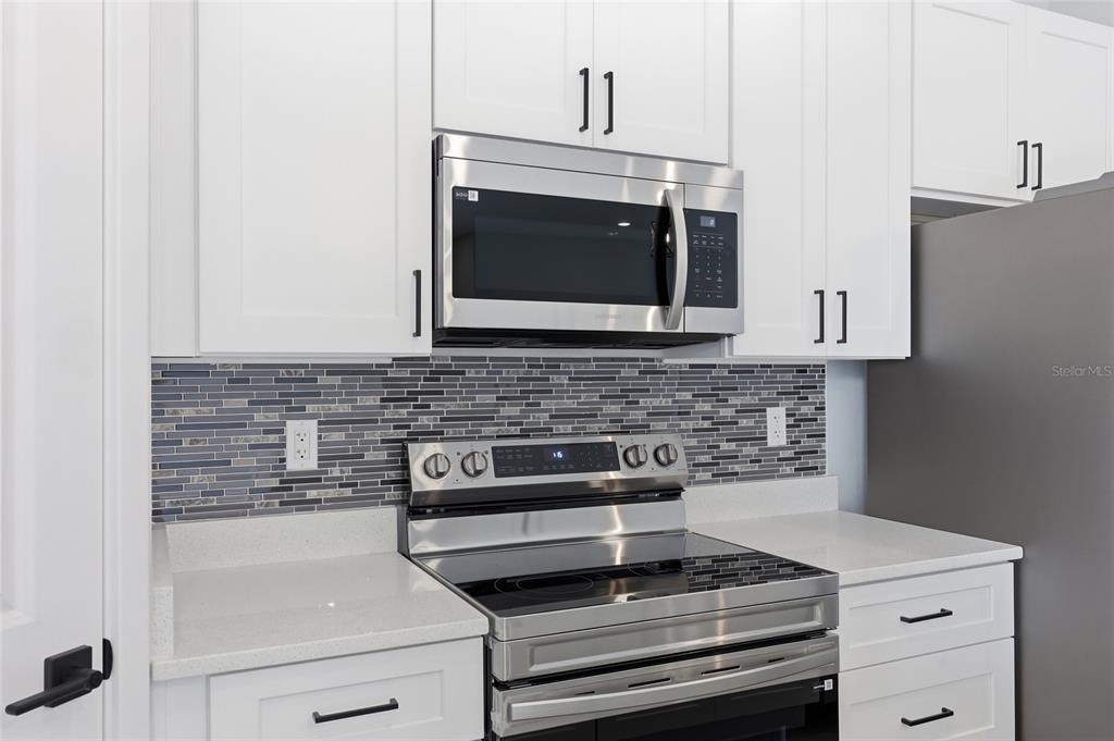 13975 Southwest 27 Ct Road Ocala, FL 34473 - Photo 15 of 35 a kitchen with a stove and a microwave