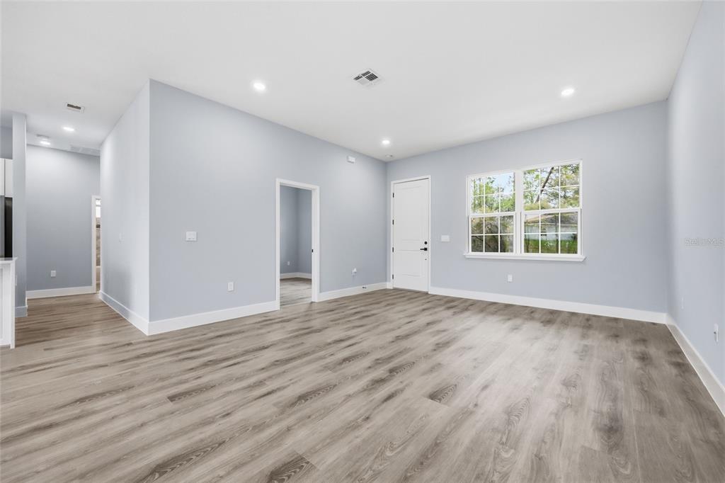 13975 Southwest 27 Ct Road Ocala, FL 34473 - Photo 17 of 35 a view of an empty room with wooden floor and a window