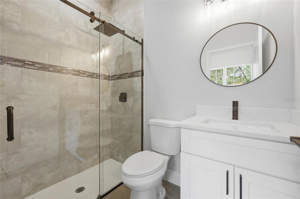 13975 Southwest 27 Ct Road Ocala, FL 34473 - Photo 27 of 35 a bathroom with a sink toilet and a mirror
