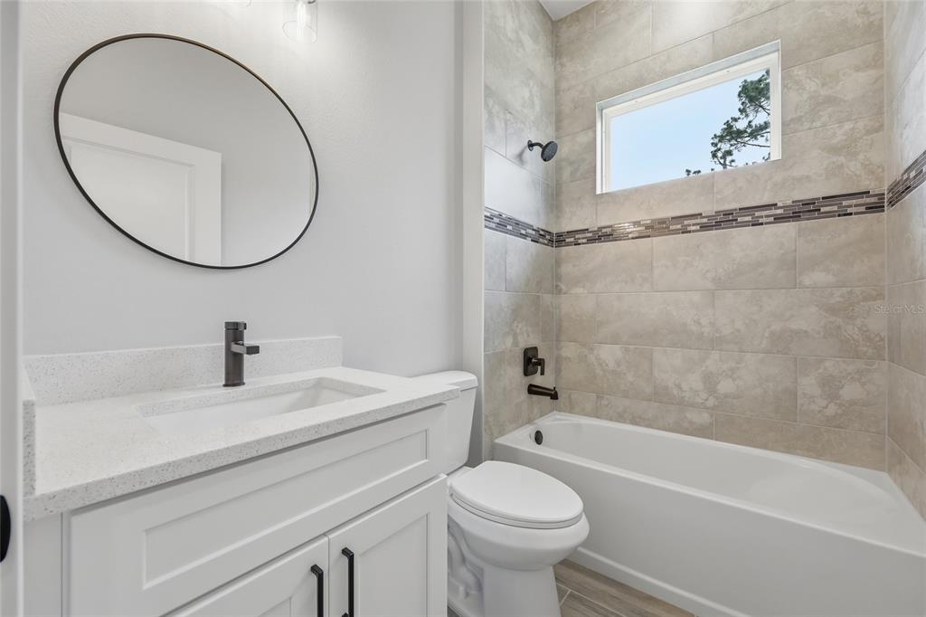 13975 Southwest 27 Ct Road Ocala, FL 34473 - Photo 28 of 35 a bathroom with a sink a toilet and a mirror