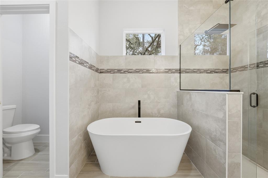 13975 Southwest 27 Ct Road Ocala, FL 34473 - Photo 32 of 35 a white bath tub sitting next to a white toilet