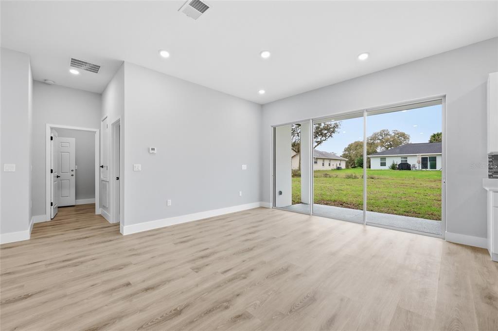 13975 Southwest 27 Ct Road Ocala, FL 34473 - Photo 8 of 35 a view of a room with wooden floor and garden