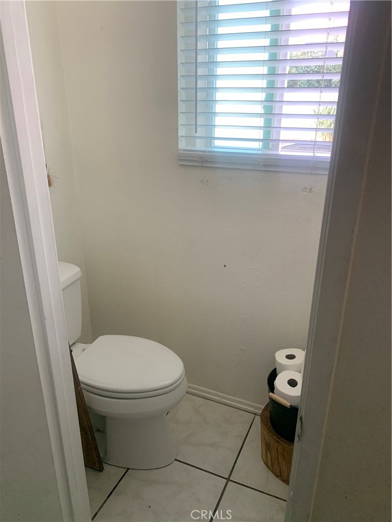 1144 North Glenwood Avenue Rialto, CA 92376 - Photo 12 of 35 a white toilet sitting next to a window
