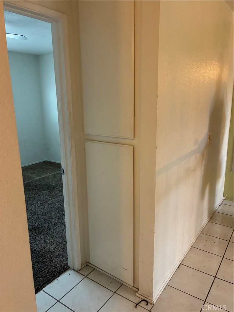 1144 North Glenwood Avenue Rialto, CA 92376 - Photo 23 of 35 a view of a hallway with a white door