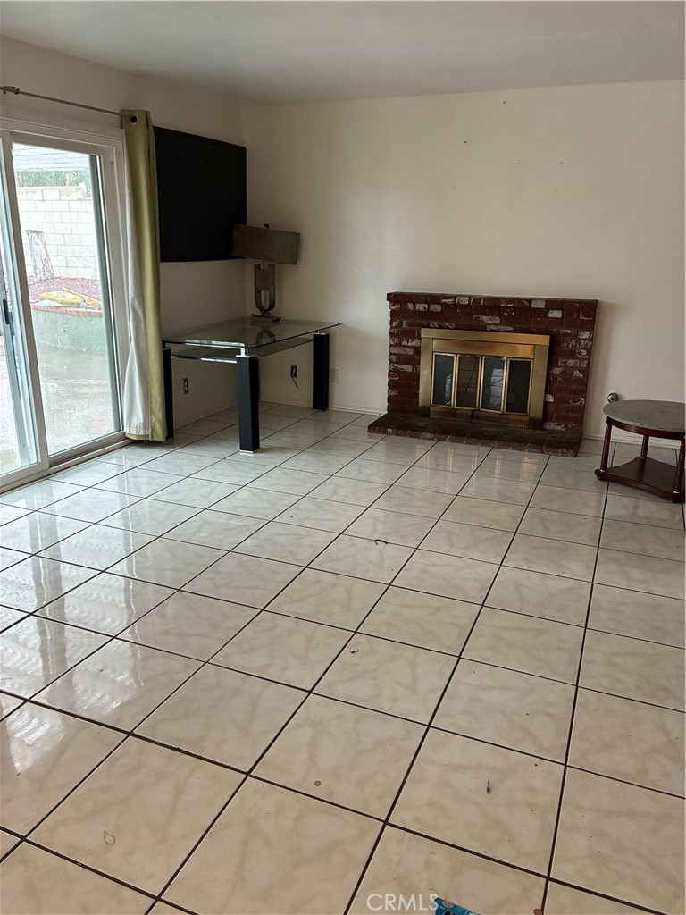 1144 North Glenwood Avenue Rialto, CA 92376 - Photo 33 of 35 a living room with furniture a flat screen tv and a fireplace