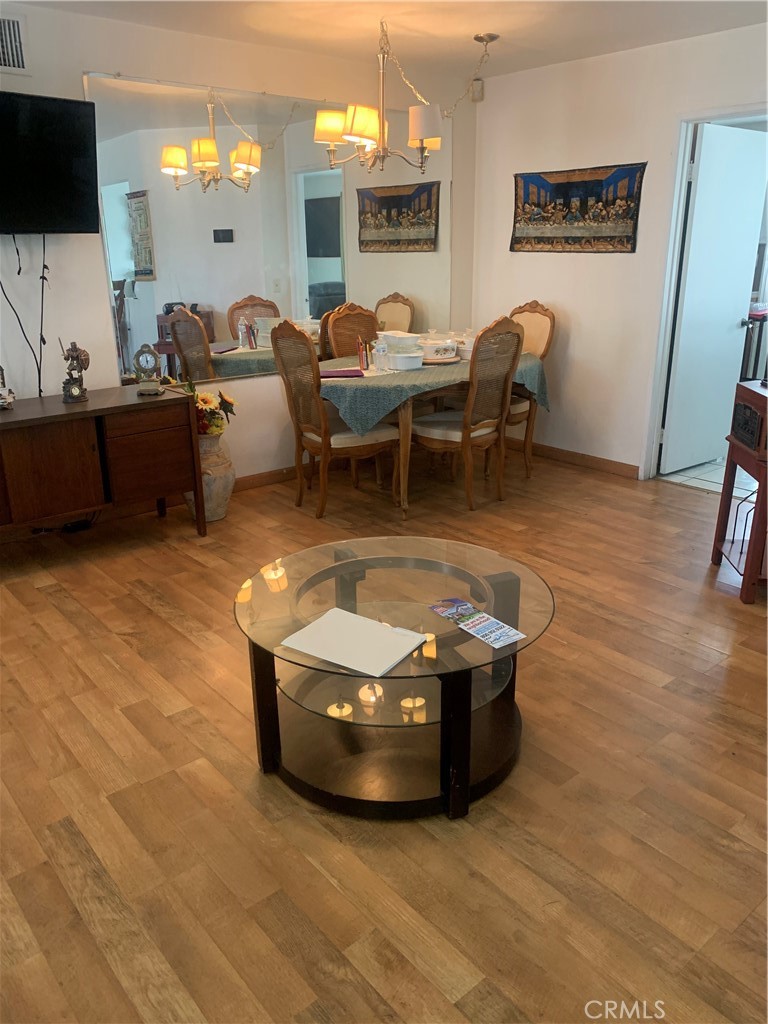 1144 North Glenwood Avenue Rialto, CA 92376 - Photo 7 of 35 a living room with couches a flat screen tv and kitchen view