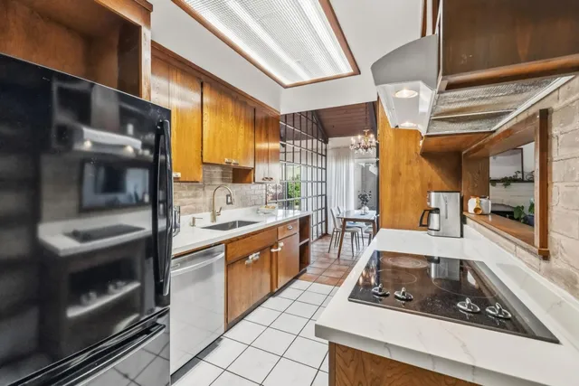a kitchen with stainless steel appliances a stove a sink and a microwave