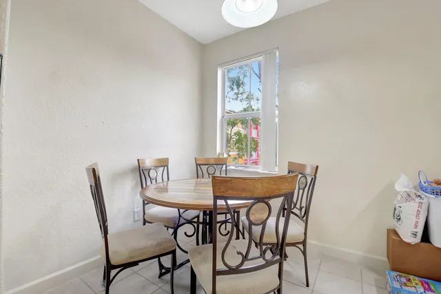 a view of a dining room with furniture and a potted plant