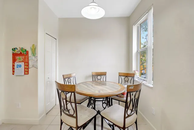 a view of a dining room with furniture and a potted plant