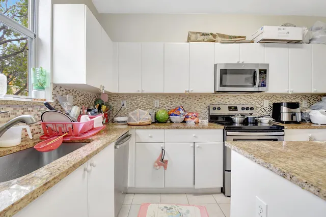 a kitchen with stainless steel appliances granite countertop a sink and cabinets
