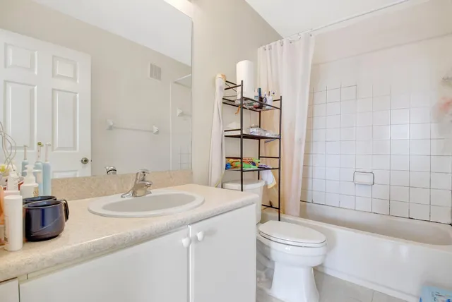 a bathroom with a toilet sink and shower