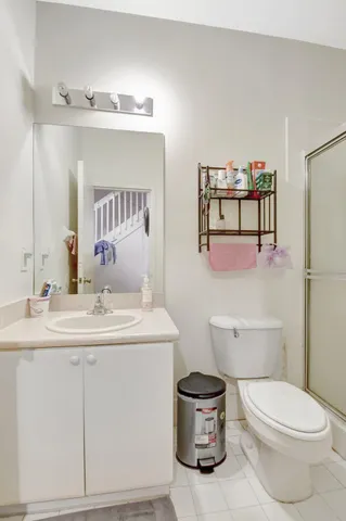 a bathroom with a sink a toilet and mirror